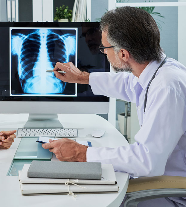 Doctor and patient look at lung x-ray