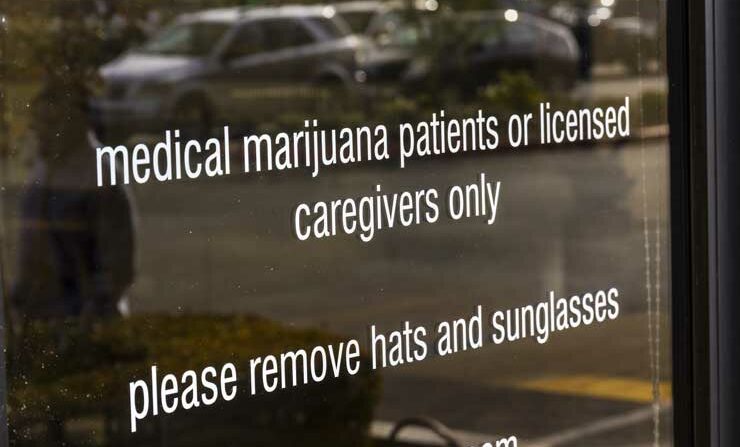 A sign on the door of a medical marijuana dispensary. (Jonathan Weiss/Shutterstock)