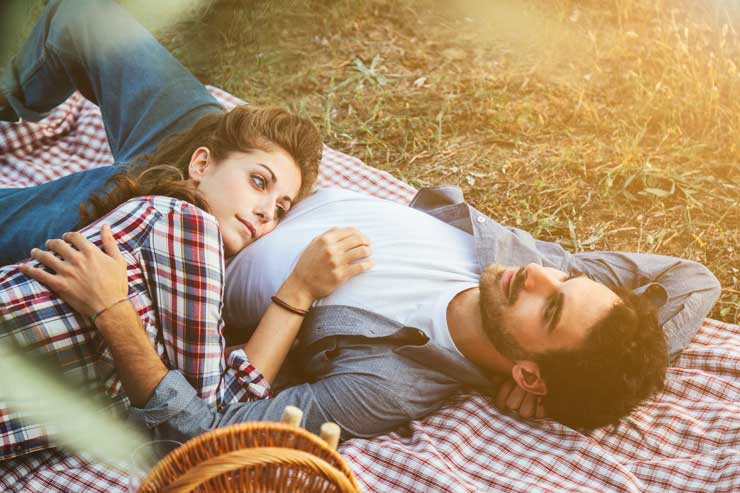 Couple cuddling on a picnic