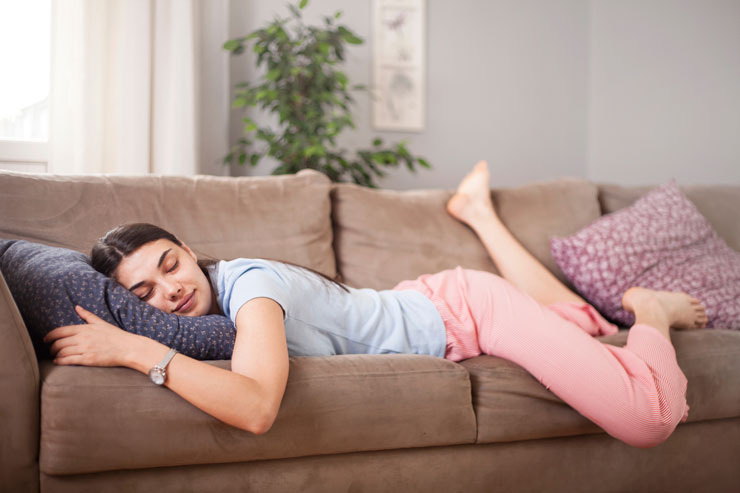 A woman sleeping on a couch
