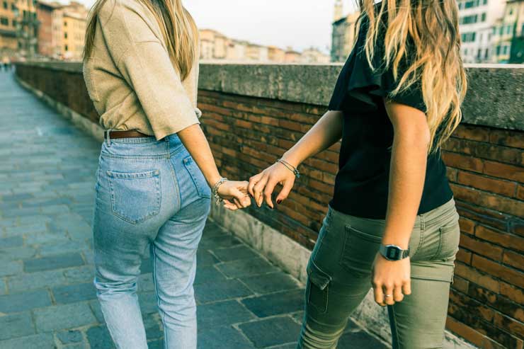 Women walking holding hands