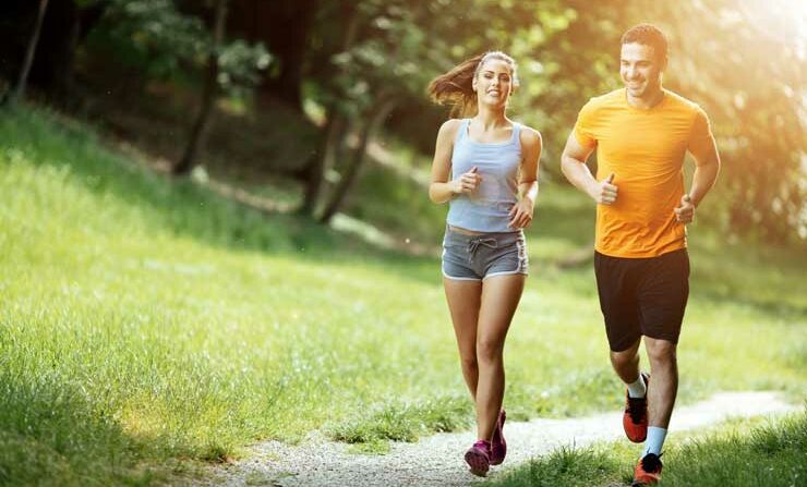 Man and woman running in park