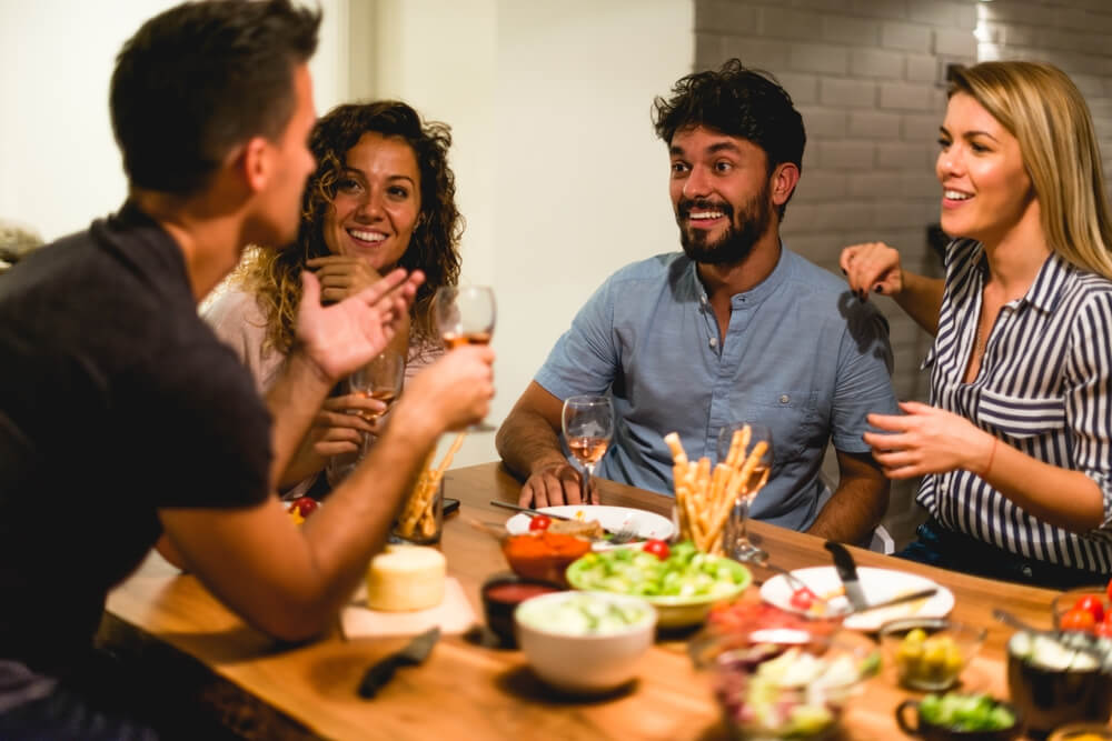 Enjoying dinner with friends at home