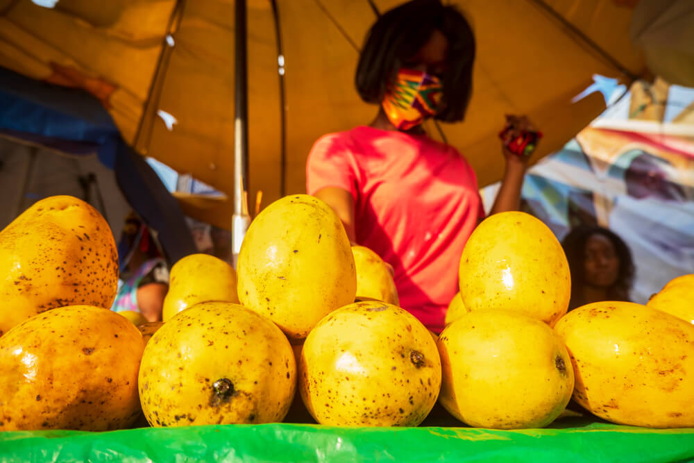 Mangos being sold at a stand in a market 