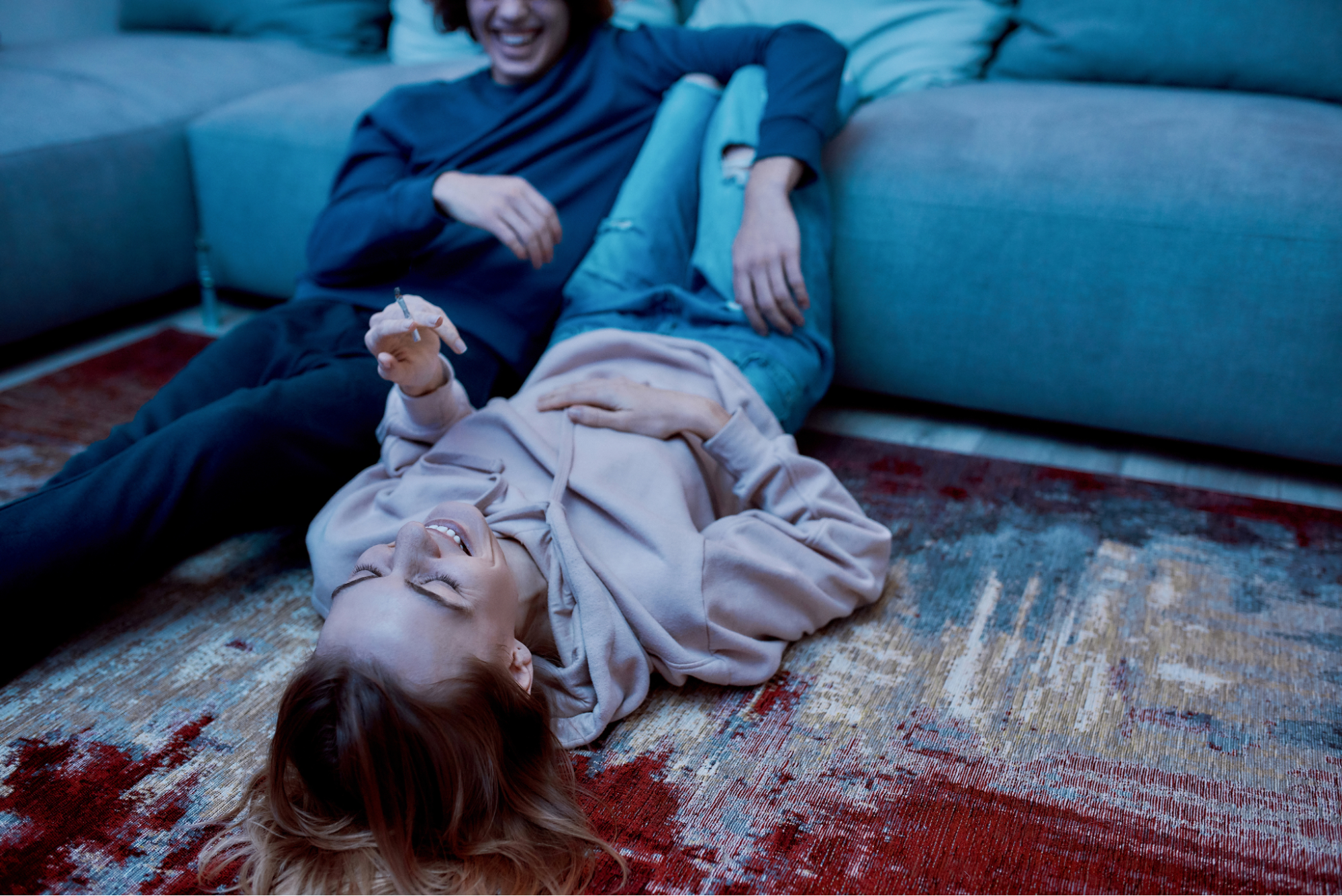 A couple smoking a joint together having fun