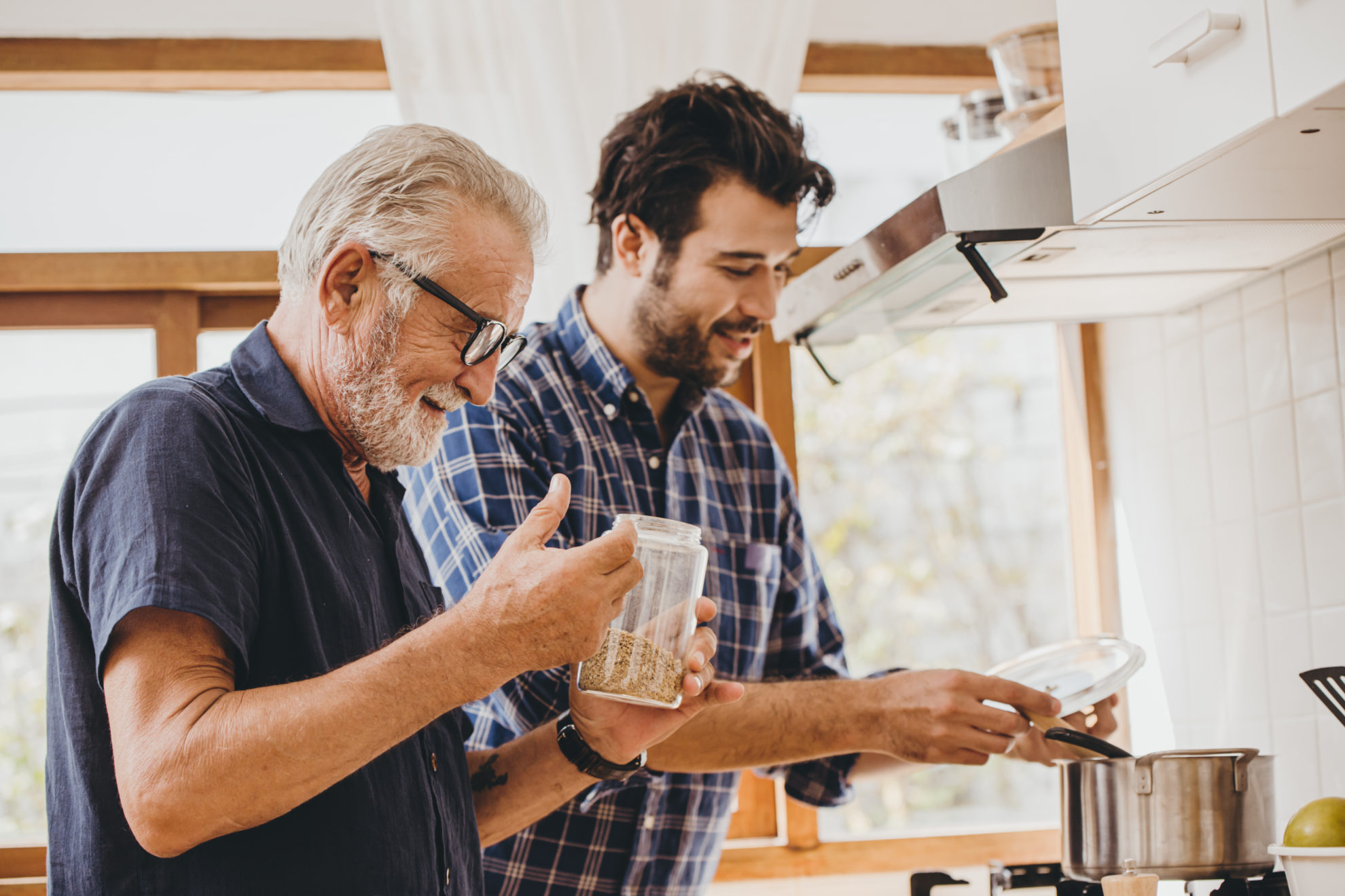 Elder cooking in the kitchen with his son